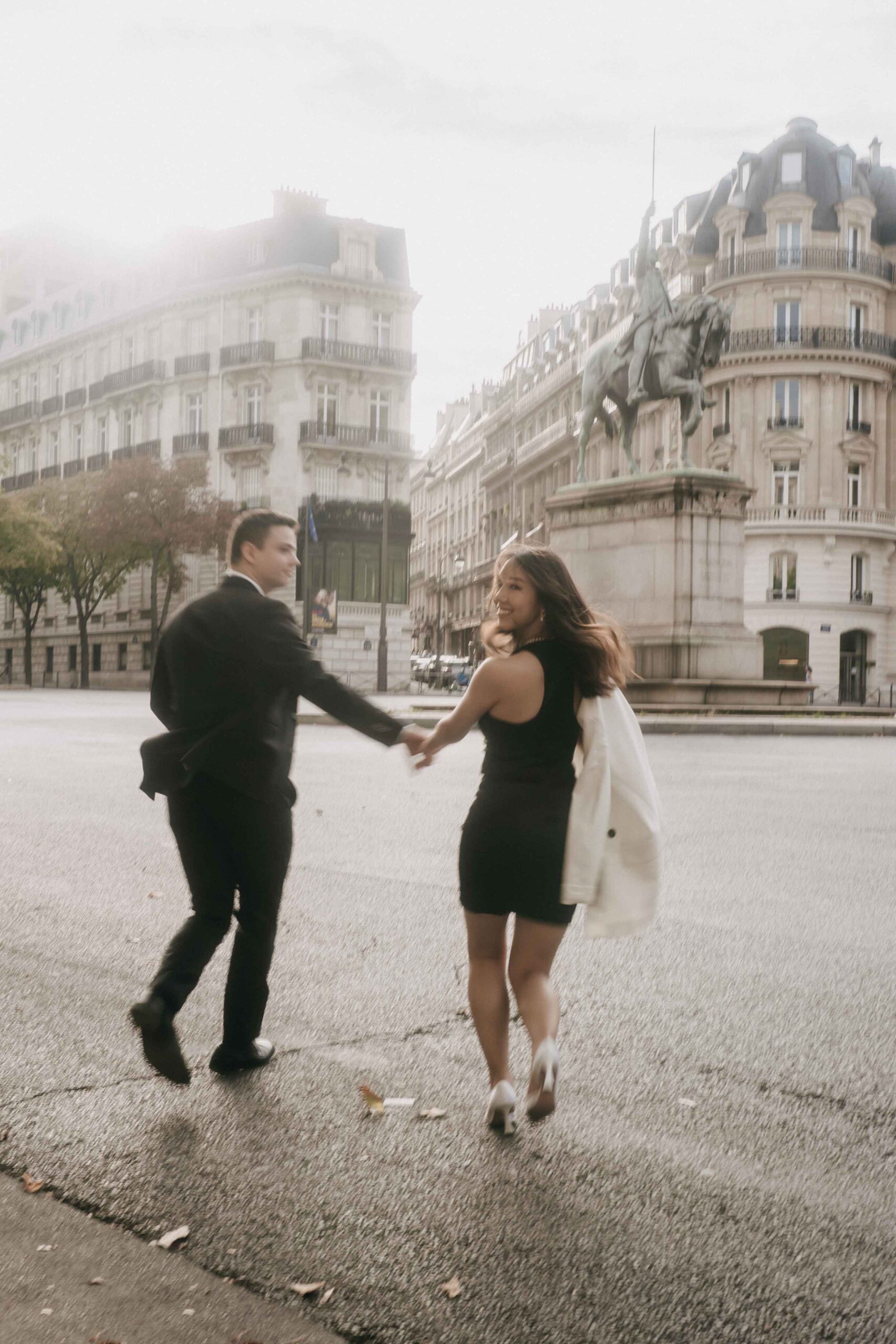 Engagement photos in Paris couple running in the street