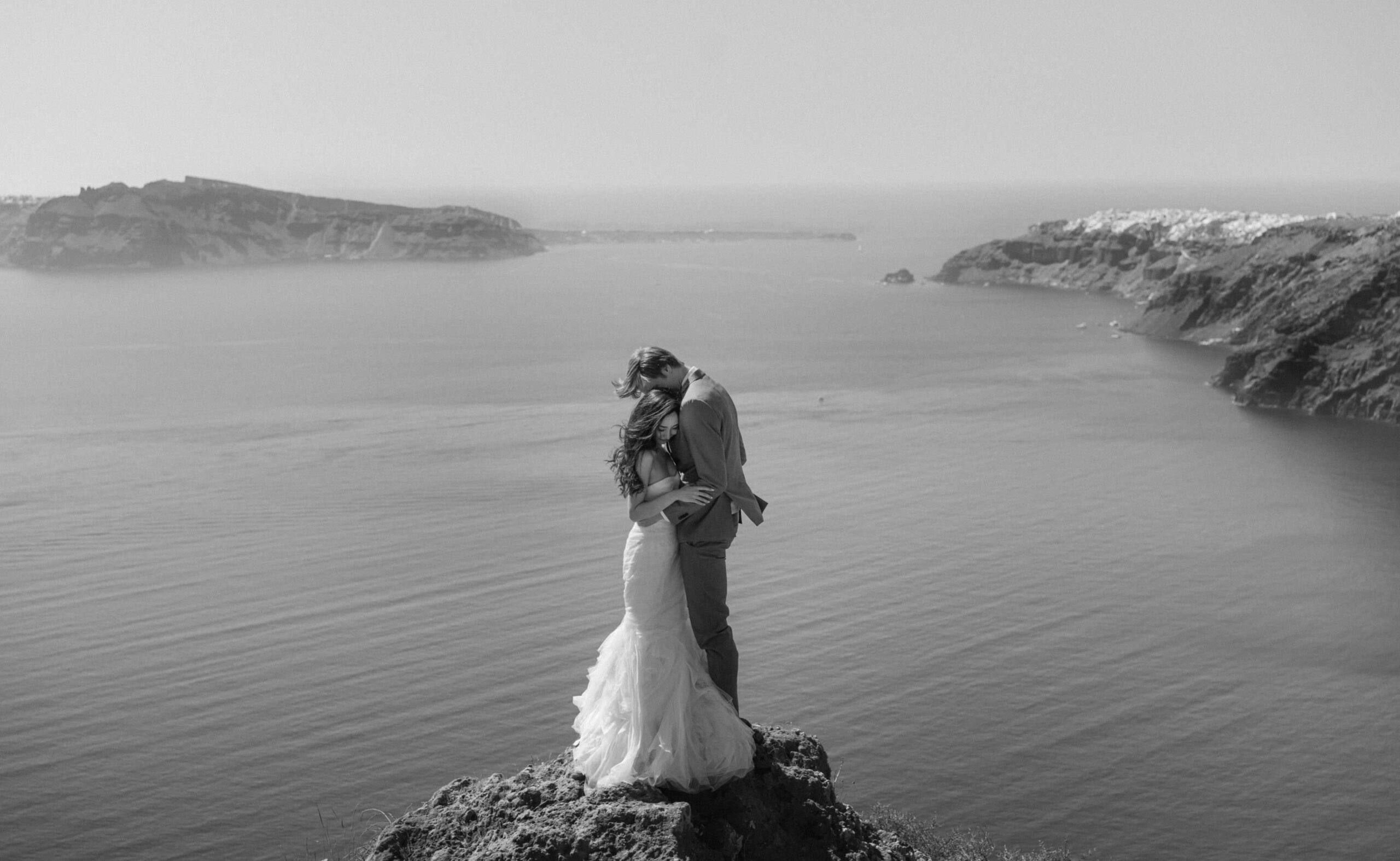 Couple alone on an empty Santorini caldera path during a wedding session.