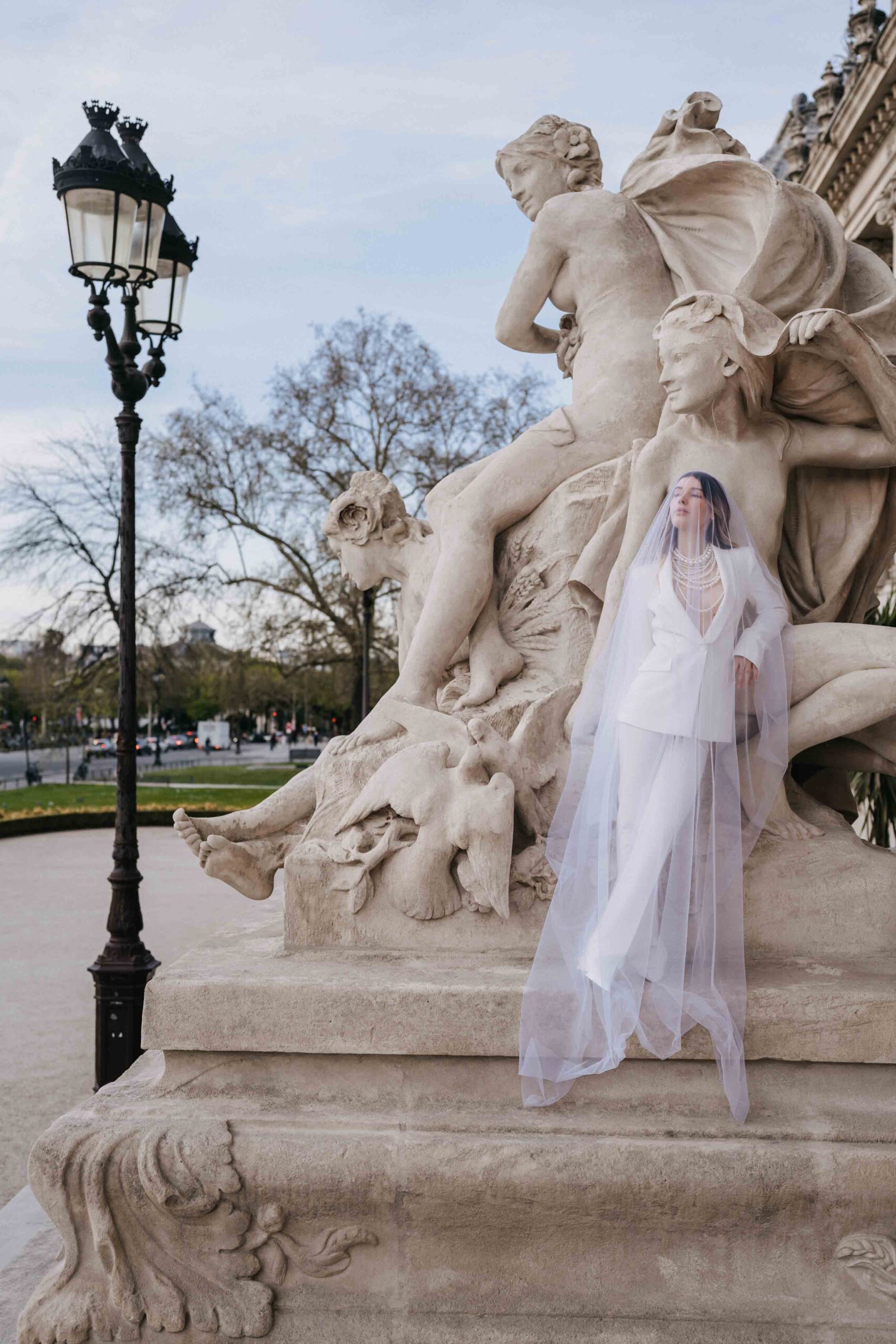 Monument statue in morning light during a permitted Paris wedding session.
