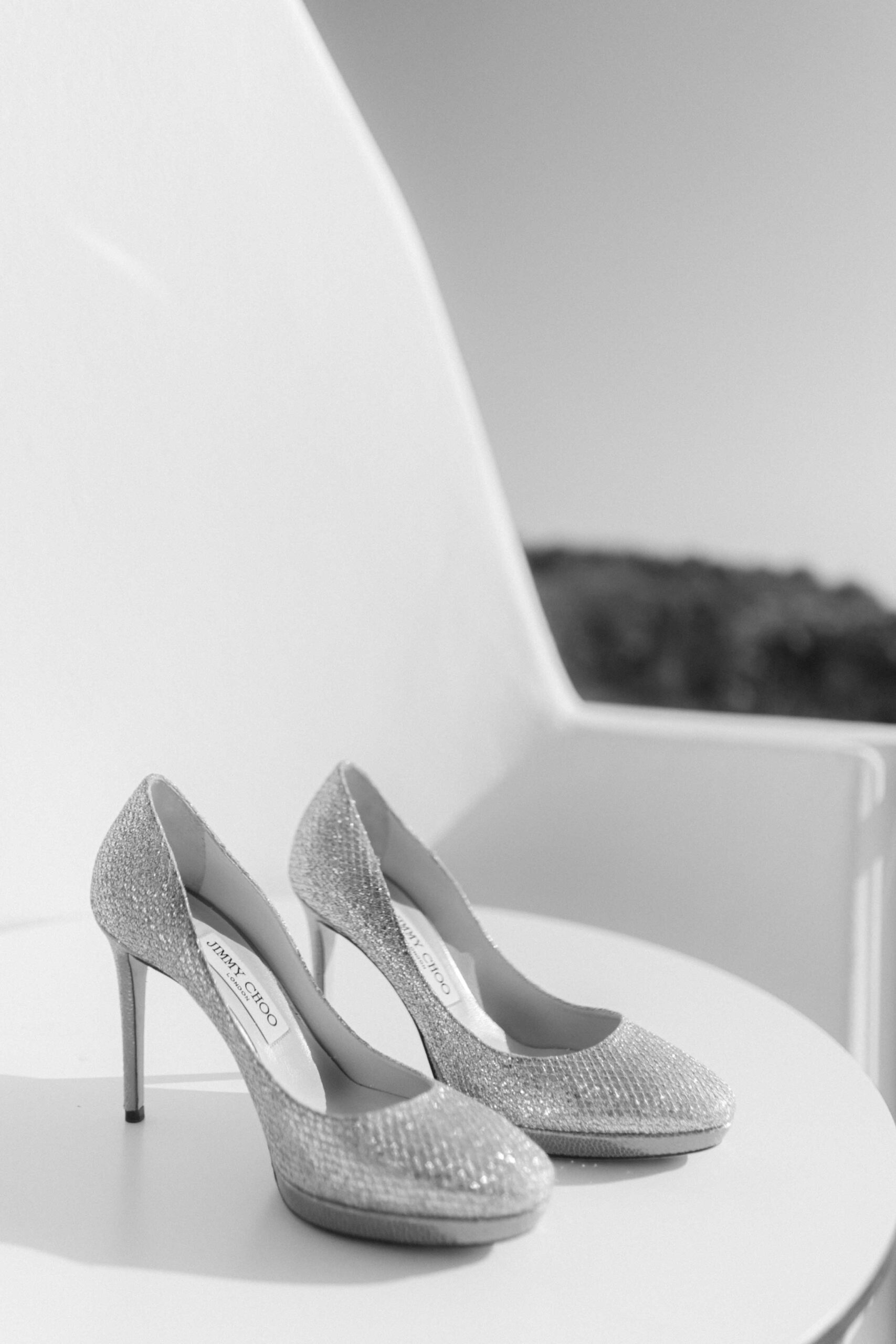 Bridal shoes in soft shaded light during a Santorini wedding morning.