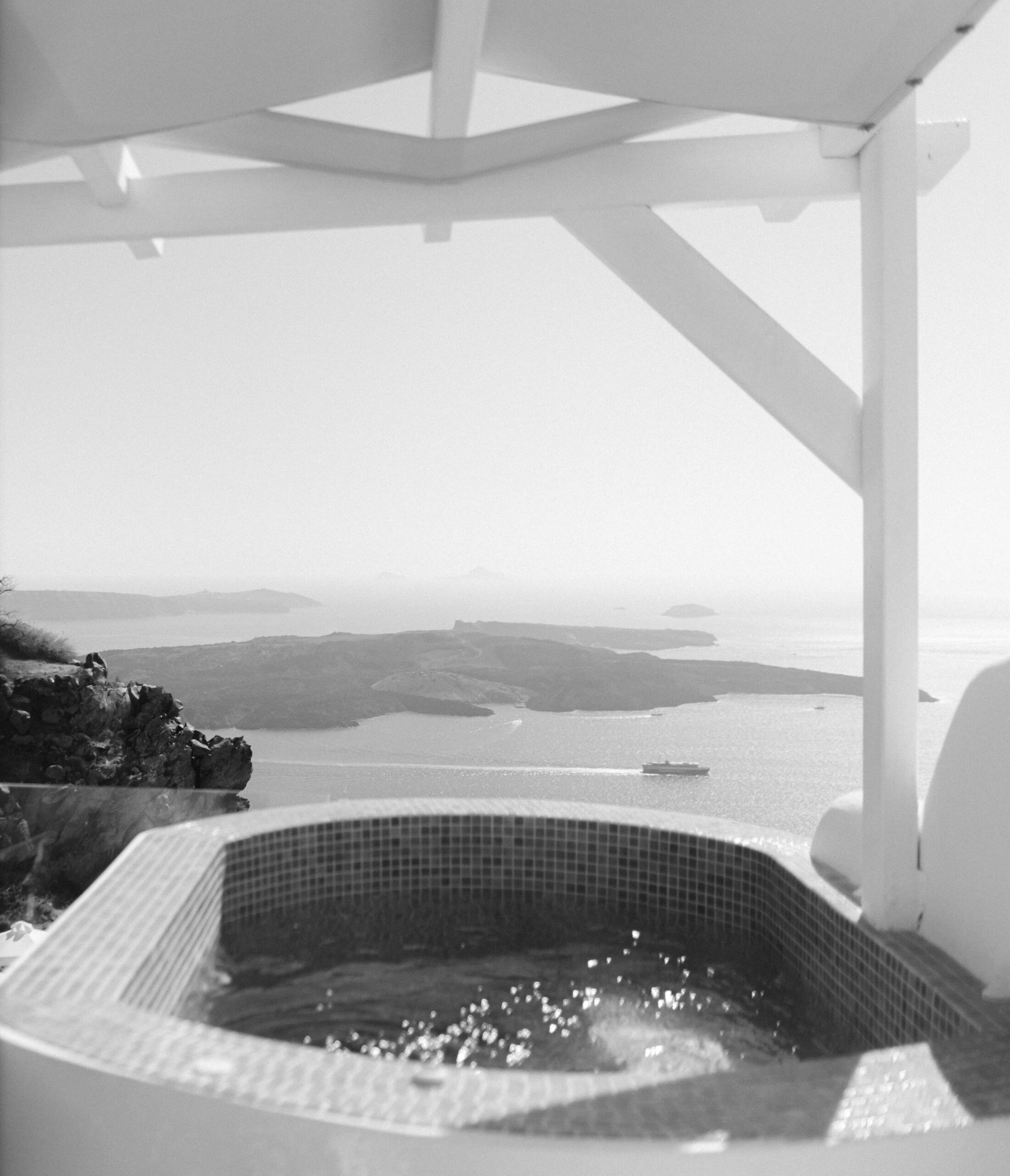 Private Santorini hotel pool terrace overlooking the caldera.