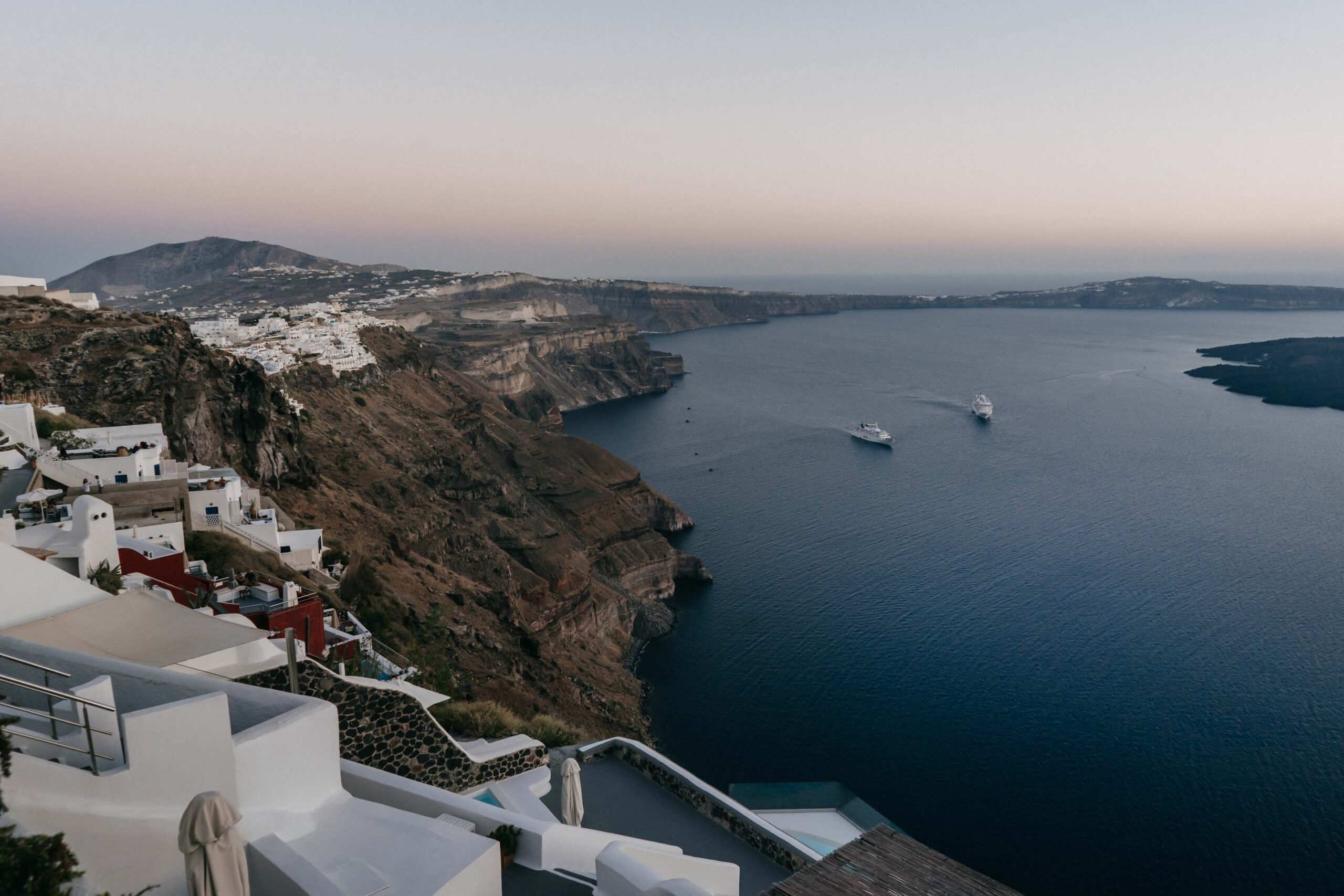 Cruise ships at anchor below the Santorini caldera villages.
