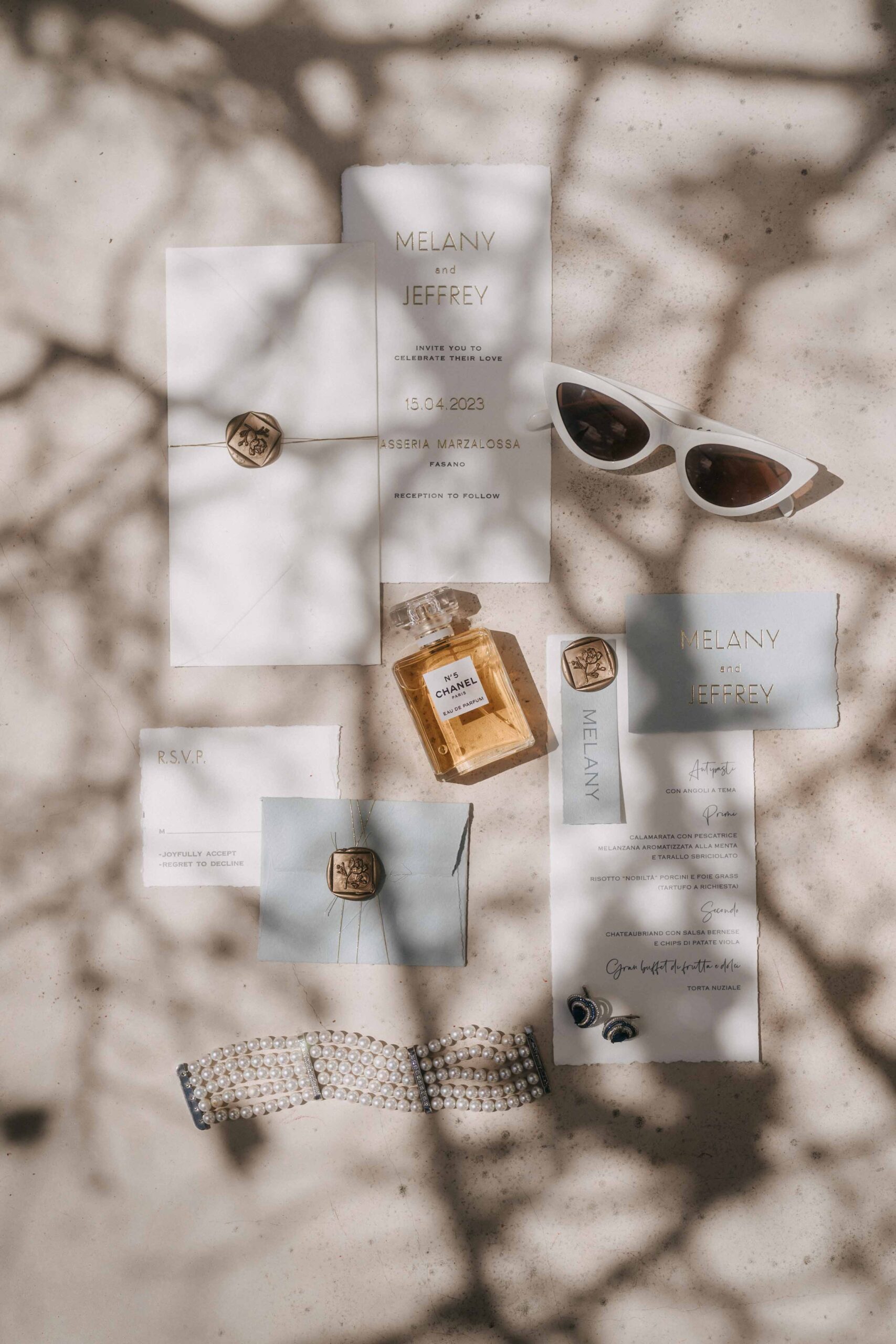 Wedding stationery flat lay in hard midday shade at Masseria Marzalossa, Fasano, Puglia